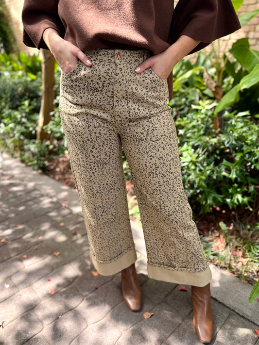 Person wearing patterned pants and brown shoes in an outdoor setting